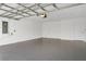 Spacious garage with an epoxy floor, brick walls, and an overhead door at 2786 Top Hill Ct, Minneola, FL 34715