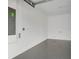A simple garage with light grey walls and a dark epoxy floor at 2786 Top Hill Ct, Minneola, FL 34715
