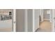 Hallway featuring views of the kitchen and dining area through the doors at 2786 Top Hill Ct, Minneola, FL 34715