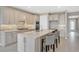 Modern kitchen boasts a large island with seating, stainless appliances, and stylish backsplash at 2786 Top Hill Ct, Minneola, FL 34715