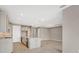 Bright, open kitchen with an island, modern cabinets, and tile flooring leading to an adjacent living area at 2786 Top Hill Ct, Minneola, FL 34715