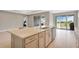 Spacious kitchen features a large island, modern appliances, and sliding glass doors to the outdoor space at 2786 Top Hill Ct, Minneola, FL 34715
