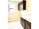 Practical laundry room has storage cabinets, white countertop, a utility sink, and a window at 2786 Top Hill Ct, Minneola, FL 34715