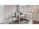 Home office features a desk, chair, modern lamp and a window for natural light at 2786 Top Hill Ct, Minneola, FL 34715