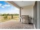 Outdoor cooking space featuring a grill with a view of a landscaped backyard at 2786 Top Hill Ct, Minneola, FL 34715