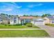 Charming one story home with a well manicured lawn, mature shrubbery and an attached two car garage at 2855 Picadilly Cir, Kissimmee, FL 34747
