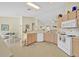 Kitchen featuring white appliances and an adjacent dining area at 2855 Picadilly Cir, Kissimmee, FL 34747