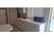 Bright kitchen with white cabinets and appliances next to the counter with a sliding glass door at 2855 Picadilly Cir, Kissimmee, FL 34747