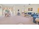 Inviting living room with a spacious layout, neutral paint, plush carpeting, and comfortable seating arrangements at 2855 Picadilly Cir, Kissimmee, FL 34747