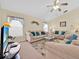 Bright living room with sofas, ceiling fan, and a television at 2855 Picadilly Cir, Kissimmee, FL 34747