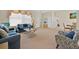 Comfortable living area featuring plush seating, neutral carpeting, and plenty of natural light at 2855 Picadilly Cir, Kissimmee, FL 34747