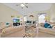 Cozy living room with neutral-toned sofas, ceiling fan, and bright windows at 2855 Picadilly Cir, Kissimmee, FL 34747