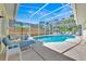 Relax by the pool in the screened-in patio area at 2855 Picadilly Cir, Kissimmee, FL 34747