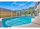 Sparkling screened-in pool is surrounded by a patio with ample space for lounging and outdoor enjoyment at 2855 Picadilly Cir, Kissimmee, FL 34747