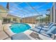 Leisurely screened-in pool area featuring lounge chairs and tables perfect for relaxation and entertaining at 2855 Picadilly Cir, Kissimmee, FL 34747