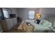 Comfortable bedroom featuring a ceiling fan, neutral walls, and a cozy bed with a bench at 3096 Maywood Ct, The Villages, FL 32162