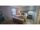 Comfortable bedroom featuring a ceiling fan, neutral walls, and a cozy bed with a bench at 3096 Maywood Ct, The Villages, FL 32162