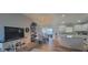 Bright dining and living area with wood floors, chandelier, and open layout to the kitchen at 3096 Maywood Ct, The Villages, FL 32162