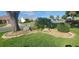 Well-maintained front yard with a unique rock and shrub garden bed at 3096 Maywood Ct, The Villages, FL 32162