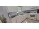 Well-lit kitchen showcasing granite counters, white appliances, and wood flooring at 3096 Maywood Ct, The Villages, FL 32162