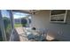 Covered patio area with outdoor dining table and chairs, perfect for entertaining at 3096 Maywood Ct, The Villages, FL 32162