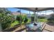 Relaxing screened-in patio area with a glass table and a lovely garden view at 3096 Maywood Ct, The Villages, FL 32162