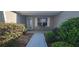 Cozy front porch with seating area, surrounded by lush greenery and manicured landscaping at 3096 Maywood Ct, The Villages, FL 32162