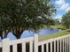 Scenic view of a pond from behind a white picket fence at 3325 Archer Ave, The Villages, FL 32162