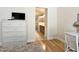 Bright bedroom featuring hardwood floors and ensuite bathroom with shower, vanity and modern fixtures at 3325 Archer Ave, The Villages, FL 32162