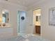 View from bedroom featuring tile floors, bathroom, cabinets, and large mirror at 3325 Archer Ave, The Villages, FL 32162