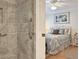 Peeking into this bedroom, there is a tile shower and seating and large bedroom with hardwood floors at 3325 Archer Ave, The Villages, FL 32162