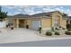 Inviting one-story home with a beige exterior, well-maintained landscaping, and a concrete driveway at 3325 Archer Ave, The Villages, FL 32162