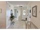Inviting hallway features neutral tile flooring, elegant decor, and a welcoming front door with decorative glass at 3325 Archer Ave, The Villages, FL 32162