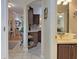 Open floorplan with views into the bathroom, bedroom, and living room, featuring neutral tile and hardwood flooring at 3325 Archer Ave, The Villages, FL 32162