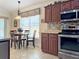 Charming kitchen nook features wooden cabinets, stainless steel appliances, and a cozy dining area with natural light at 3325 Archer Ave, The Villages, FL 32162