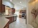 Well-lit kitchen featuring stainless steel appliances, wooden cabinets, tile backsplash, and spacious countertops at 3325 Archer Ave, The Villages, FL 32162