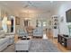 Cozy living room with hardwood floors, a ceiling fan, and an open view of the dining area at 3325 Archer Ave, The Villages, FL 32162