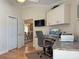 Bright home office with custom built-ins, desk, ceiling fan, backyard view and decorative lighting at 3325 Archer Ave, The Villages, FL 32162