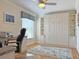 Office with built-in shelving, Murphy bed, desk, ceiling fan and large window for natural lighting at 3325 Archer Ave, The Villages, FL 32162