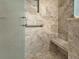 Updated shower with custom tile, built in niche, seating, and safety bar for modern accessible bathing at 3325 Archer Ave, The Villages, FL 32162