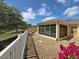 Relaxing sunroom featuring a screened enclosure, neutral-toned gravel, and a peaceful outdoor view at 3325 Archer Ave, The Villages, FL 32162