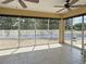 Bright sunroom with tiled floors, ceiling fans, and sliding windows that offer a serene view of the outdoors at 3325 Archer Ave, The Villages, FL 32162