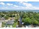 Aerial view of a neighborhood canal leading to a large lake with lush greenery, and beautiful blue skies at 33635 Jeffery Ct, Leesburg, FL 34788