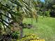 Backyard with lush lawn and landscaped garden at 33635 Jeffery Ct, Leesburg, FL 34788