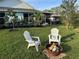 Inviting backyard featuring a fire pit and Adirondack chairs, perfect for outdoor relaxation and gatherings at 33635 Jeffery Ct, Leesburg, FL 34788