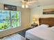 Bedroom features a tropical view outside the window, along with beach themed art at 33635 Jeffery Ct, Leesburg, FL 34788