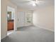 Spacious bedroom with soft carpet, ceiling fan, and a door leading to an en-suite bathroom at 33635 Jeffery Ct, Leesburg, FL 34788