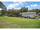 Scenic view of boat dock along waterfront with lush lawn at 33635 Jeffery Ct, Leesburg, FL 34788
