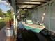 Scenic shot of a teal boat on lift with lush garden and water at 33635 Jeffery Ct, Leesburg, FL 34788