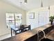 Inviting dining room featuring a dark wood table set for four near a large window providing natural light at 33635 Jeffery Ct, Leesburg, FL 34788
